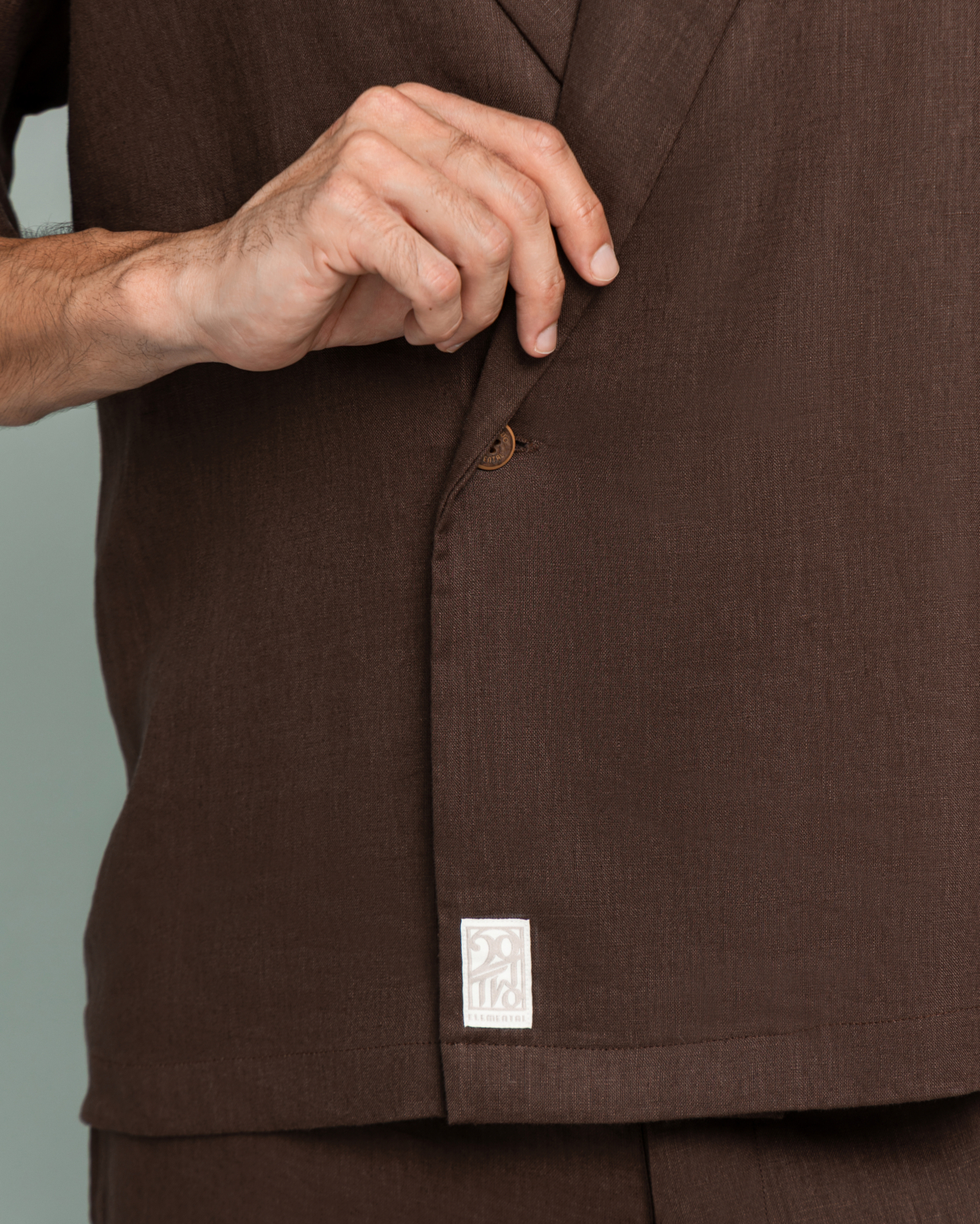 Close up of the Corozo tagua nut button on 20Two Elemental SHADE OVER-SHIRT, Desert Dusk brown linen