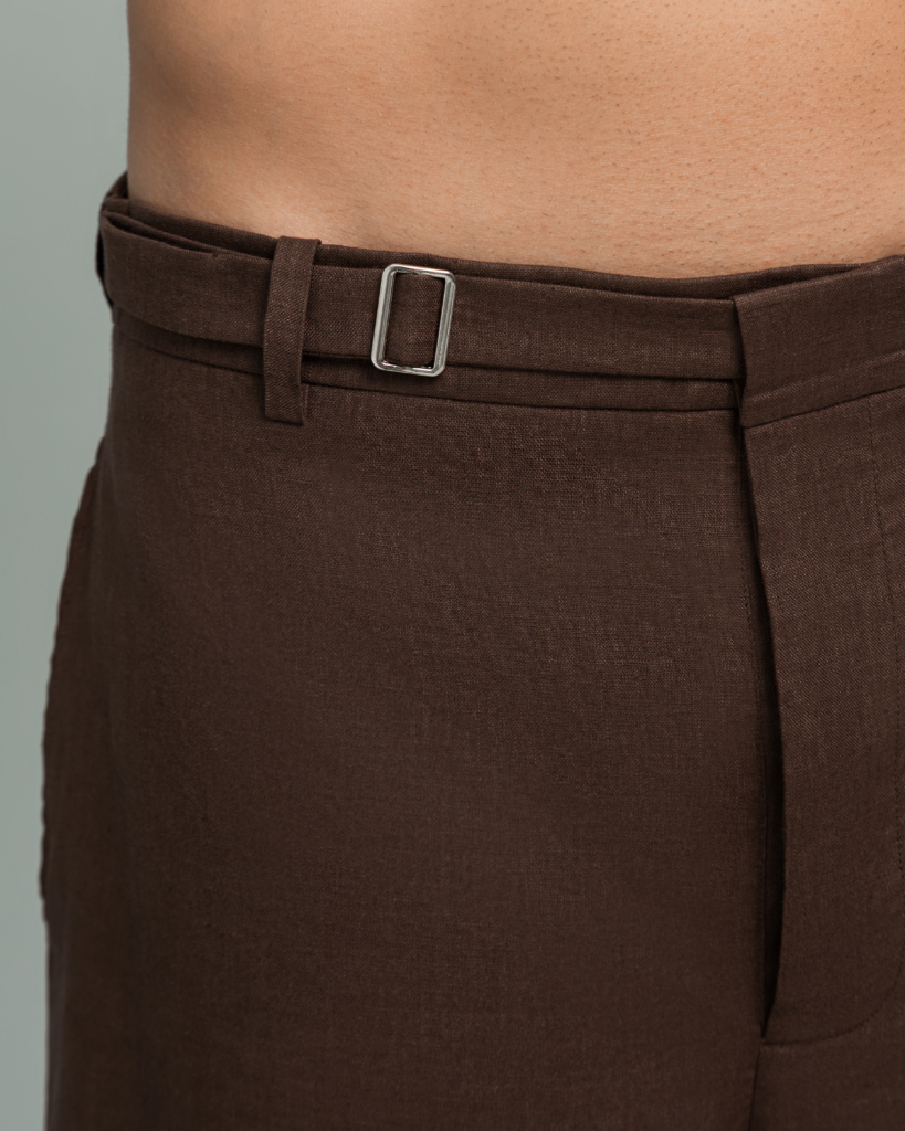 Close up of the natural shell button and metal buckle waist closure on 20Two Elemental DRIFT SHORT, Desert Dusk brown linen