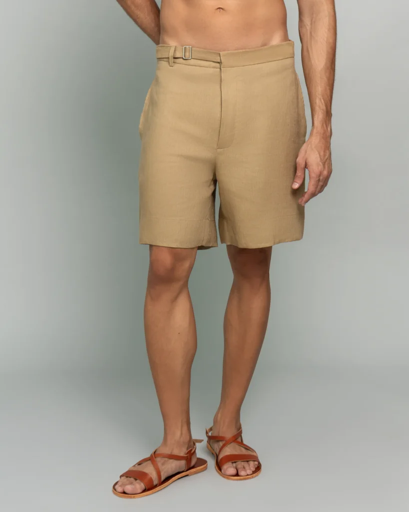 Man wearing 20Two Elemental's GHAF drift short in desert tan, front view, belted waist, cropped at the torso