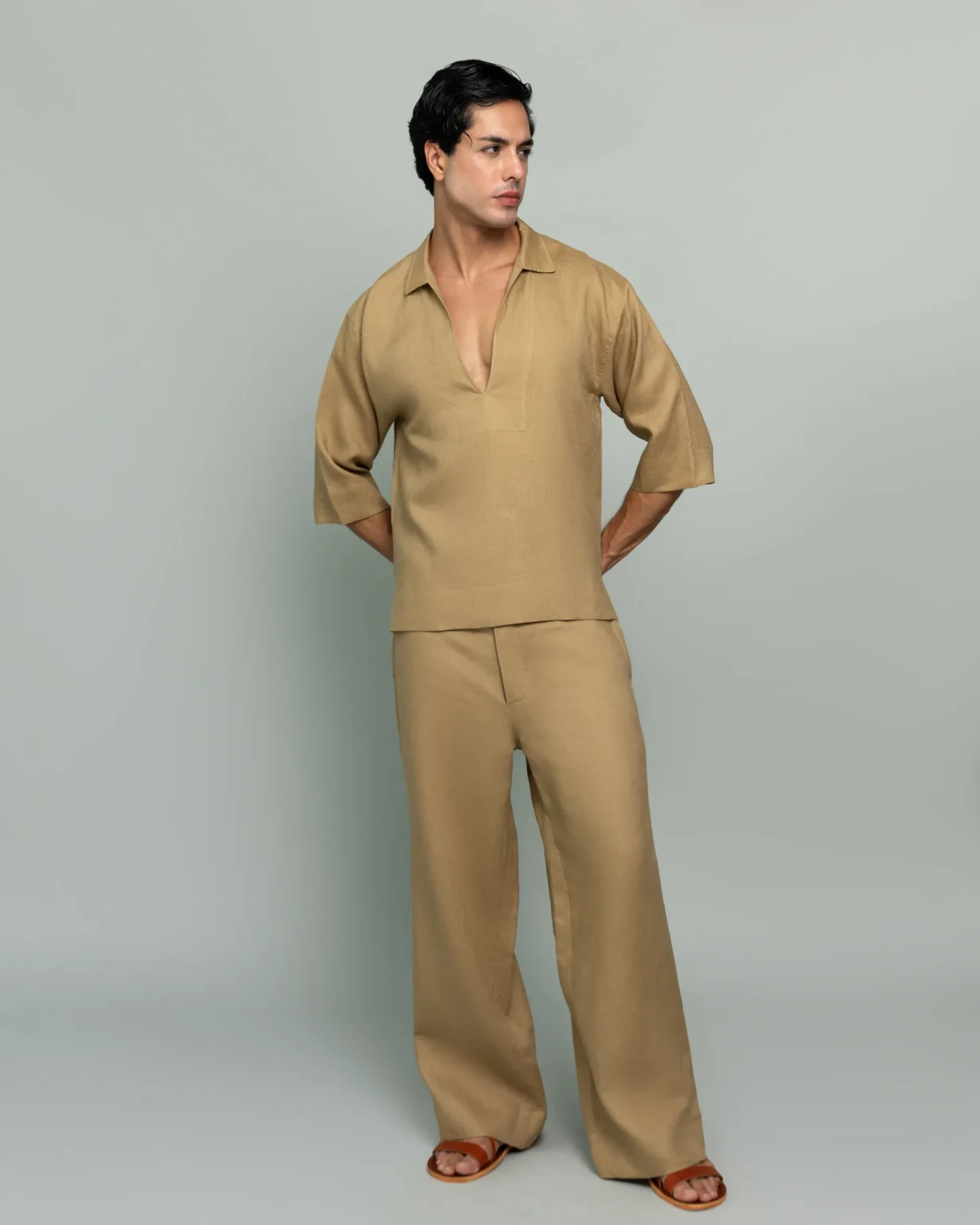 Man wearing 20Two Elemental's GHAF grain-top and rooted trouser set in desert tan, relaxed v-neck top with dropped shoulder, front view