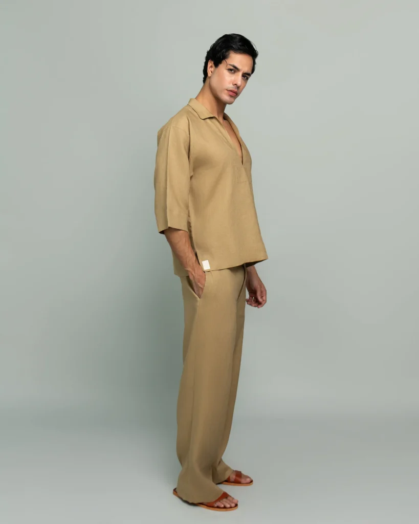 Side view of a man wearing 20Two Elemental's GHAF grain-top and rooted trouser set in desert tan