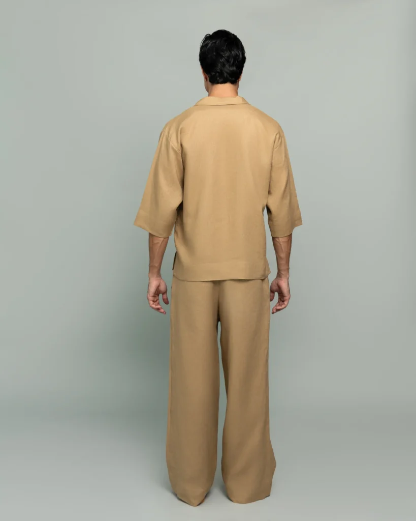 Back view of a man wearing 20Two Elemental's GHAF grain-top and rooted trouser set in desert tan