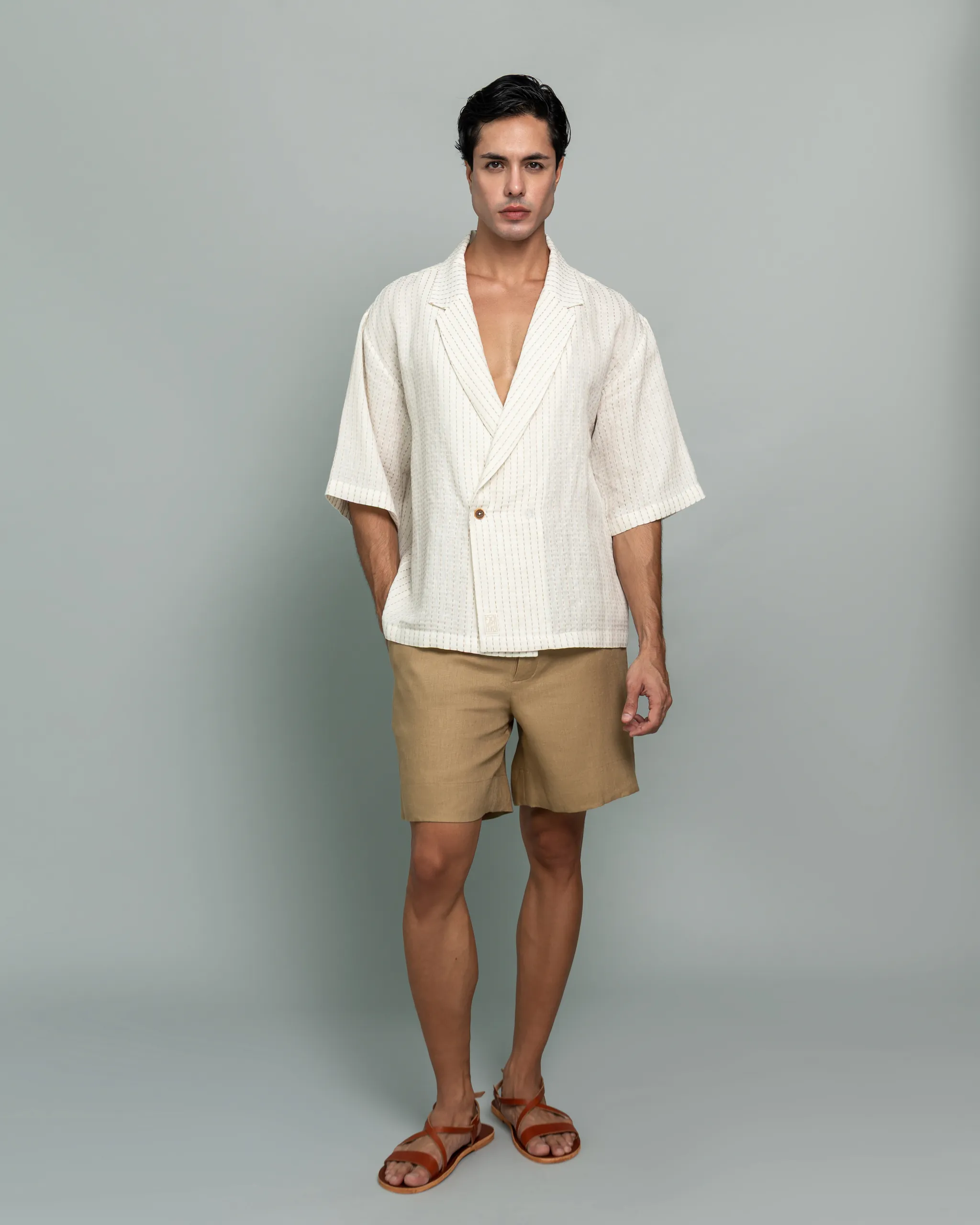Man wearing 20Two Elemental's GHAF ivory over-shirt and desert tan drift short, front view