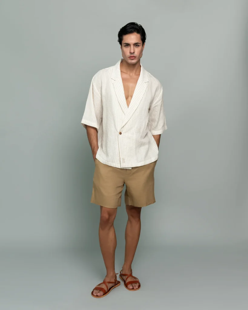 Man wearing 20Two Elemental's GHAF ivory over-shirt and desert tan drift short, front view, alternate pose