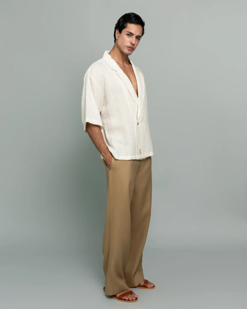 Man wearing 20Two Elemental's GHAF ivory over-shirt in a subtle stripe weave with a desert tan rooted trouser, front view, alternate pose