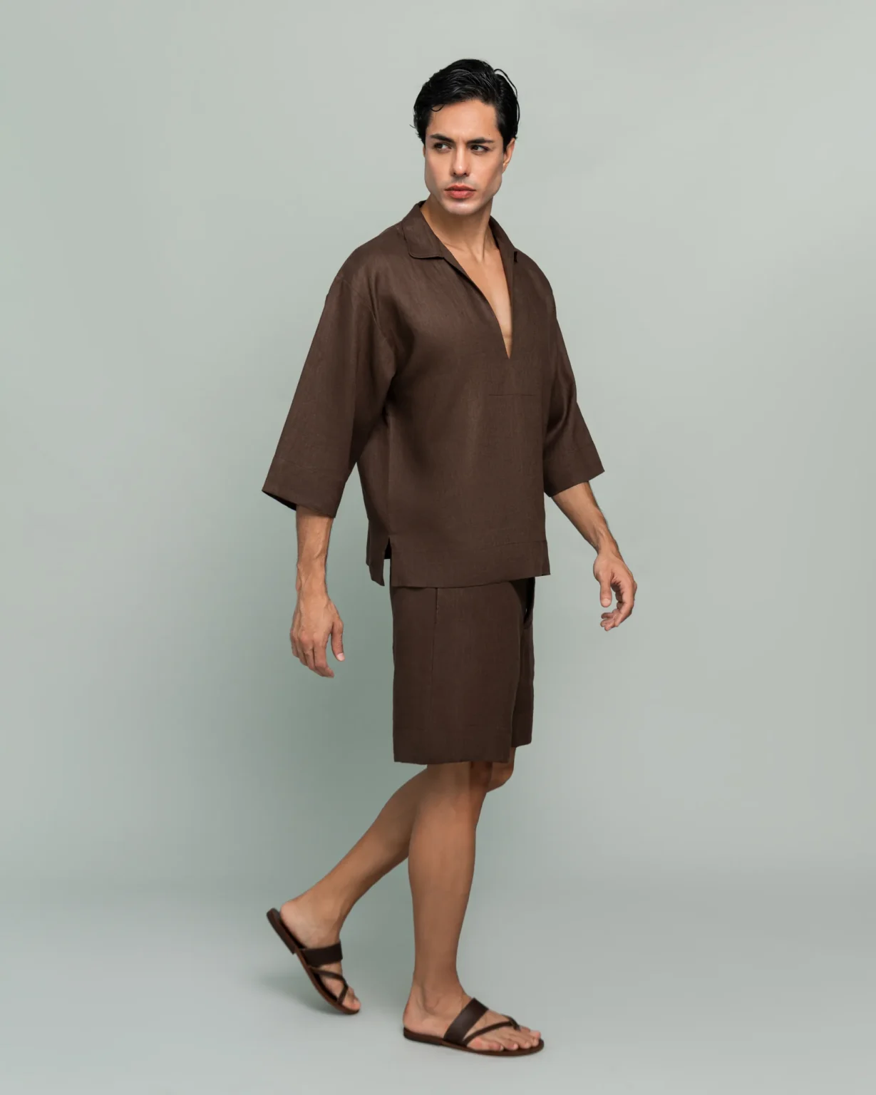 Side view of a man walking in 20Two Elemental's GHAF over-shirt and drift short set in brown