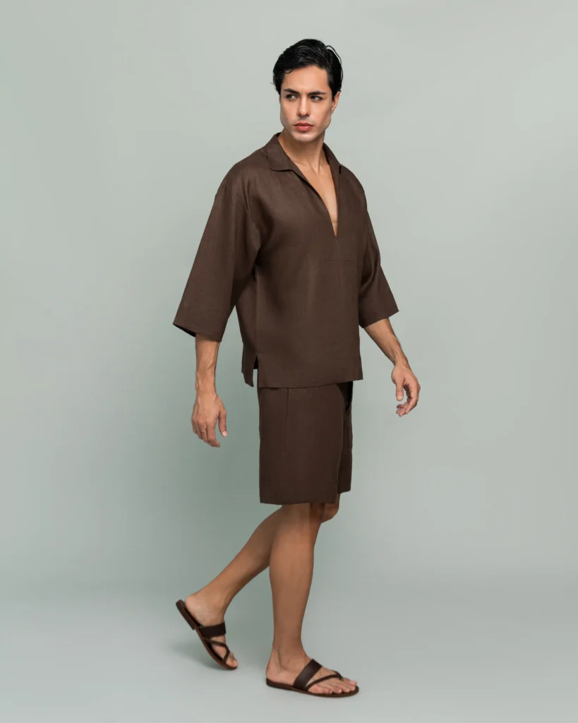 Side view of a man walking in 20Two Elemental's GHAF over-shirt and drift short set in brown