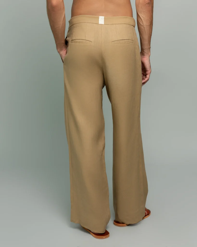 Back view of a man wearing 20Two Elemental's GHAF rooted trouser in desert tan, wide-leg silhouette
